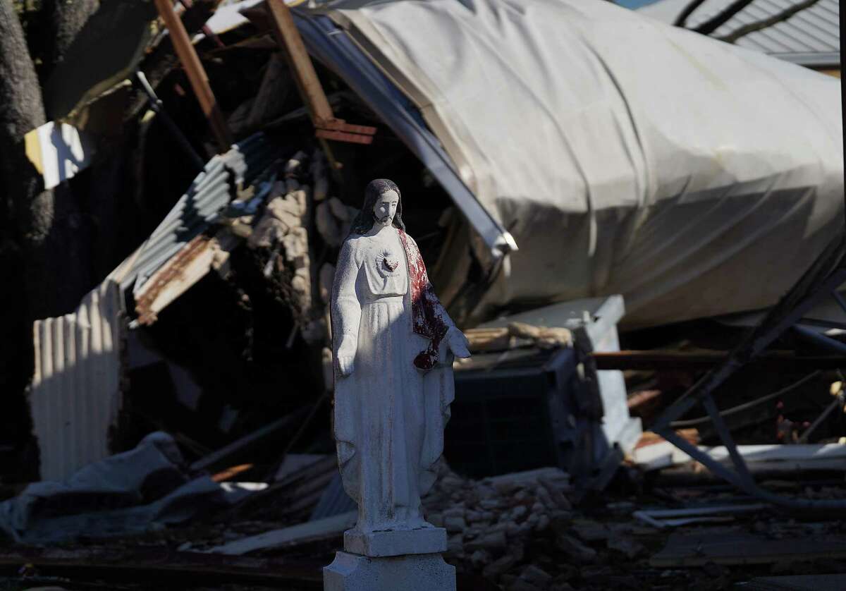 A statue sits in the courtyard of St. Hyacinth in front of a roof that came off the church following Tuesday’s tornado on Thursday, Jan. 26, 2023 in Deer Park. The EF3 tornado made ground fall on Tuesday, causing wide-spread damage and power outages.