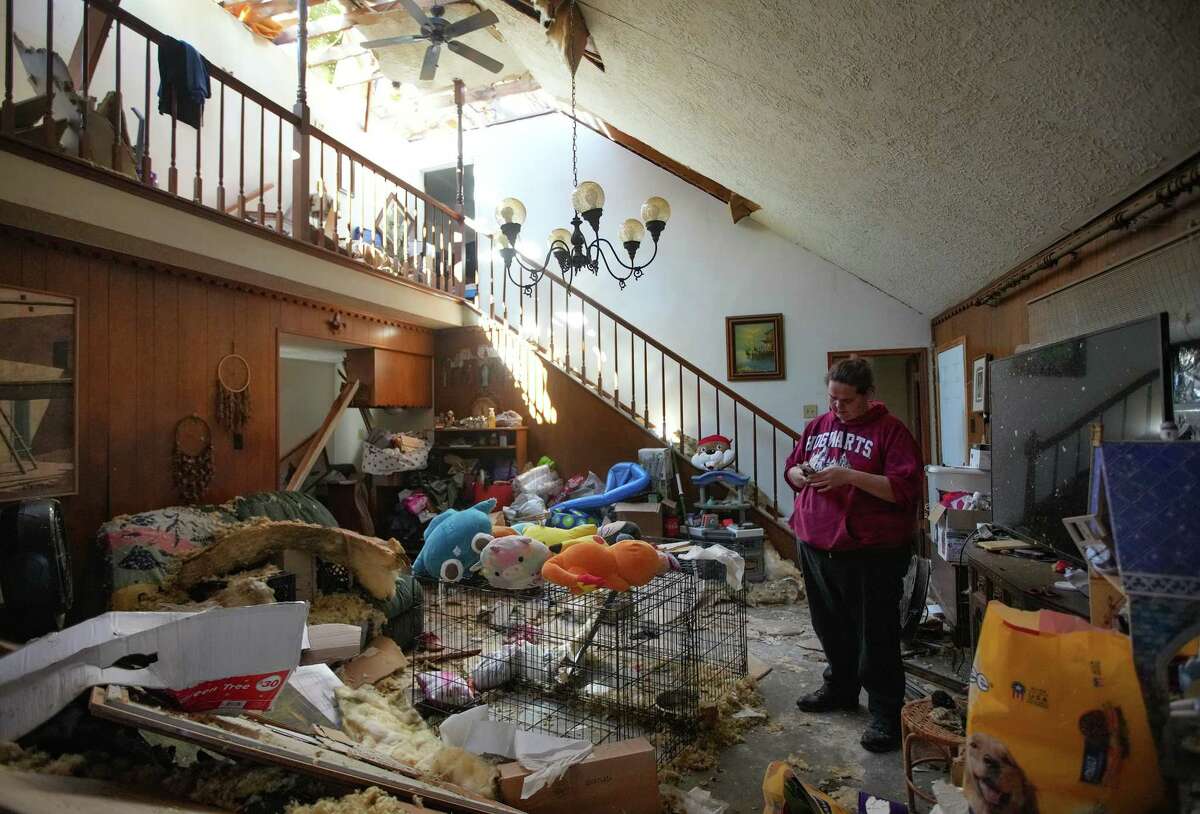 Hilarie Garza stands in the living room of her Pasadena home after it was severely damaged by Tuesday’s tornado on Thursday, Jan. 26, 2023 in Pasadena. “You spend eight years putting your life together and it’s lost in five seconds,” Garza said as she look at her home. The family had to put their two-year-old Rottweiler dogs up for adoption so they could have more options on shelter.