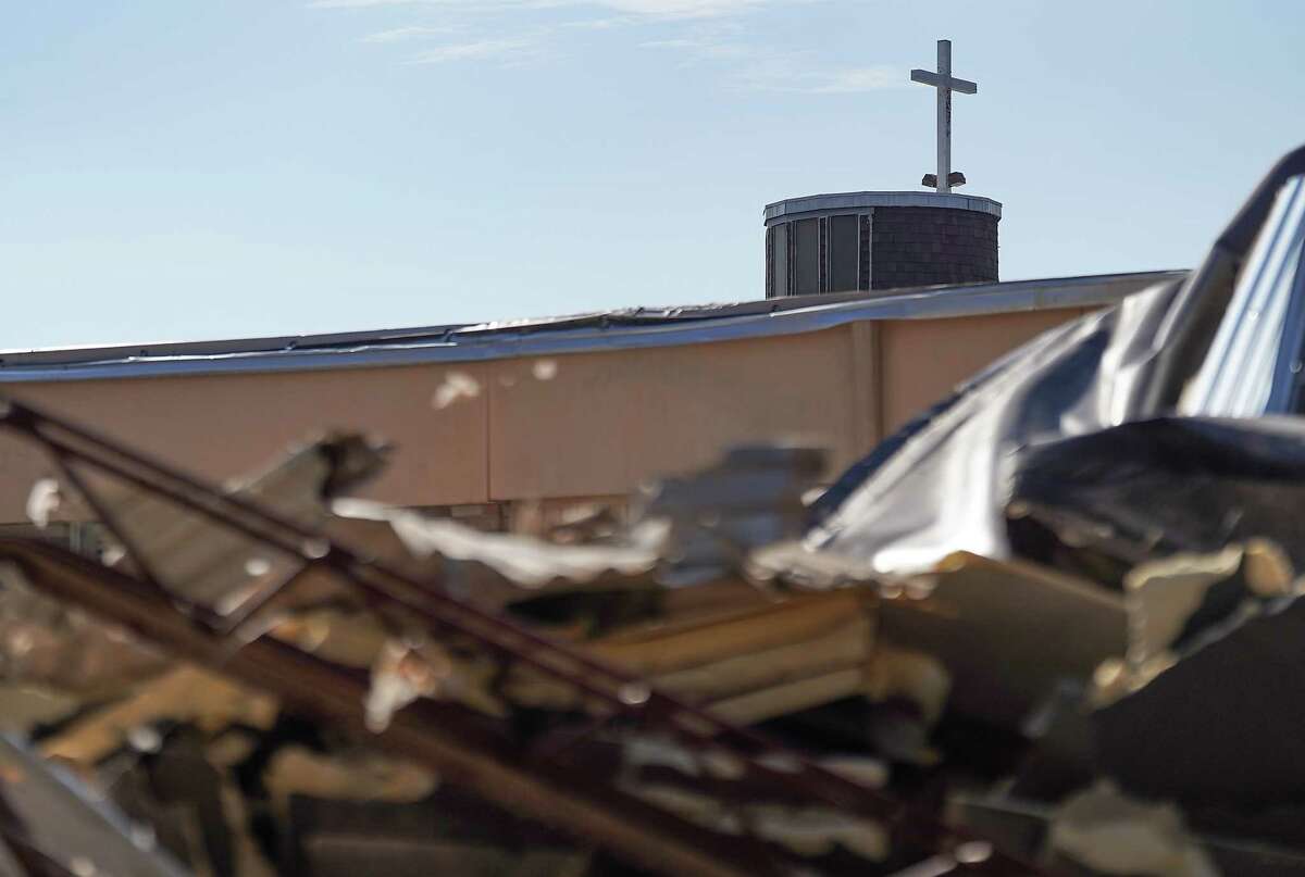 A cross remains over the sanctuary as remains of the roof sit on the ground of St. Hyacinth Catholic Church following Tuesday’s tornado on Thursday, Jan. 26, 2023 in Pasadena. The EF3 tornado made ground fall on Tuesday, causing wide-spread damage and power outages.