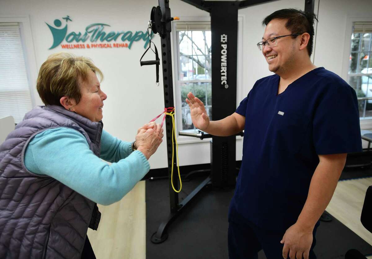 Physical therapist Rey Abadilla works on strength, flexibility, and balance with Parkinsons sufferer Martha Chutjian, of Milford, at YouTherapy Wellness & Physical Rehab at 318 New Haven Avenue in Milford, Conn. on Thursday, January 26, 2023.
