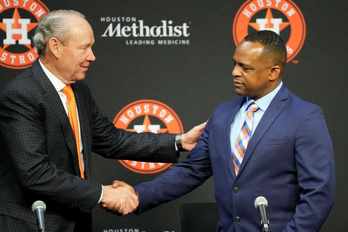 Houston Astros owner Jim Crane, left, shakes hands with Dana Brown during a news conference after Brown was hired as the Astros general manager Thursday, Jan. 26, 2023, in Houston.