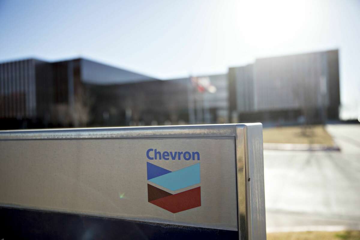 Chevron Corp. signage is displayed outside an office building in Midland, Texas, U.S., on Thursday, March 1, 2018. 
