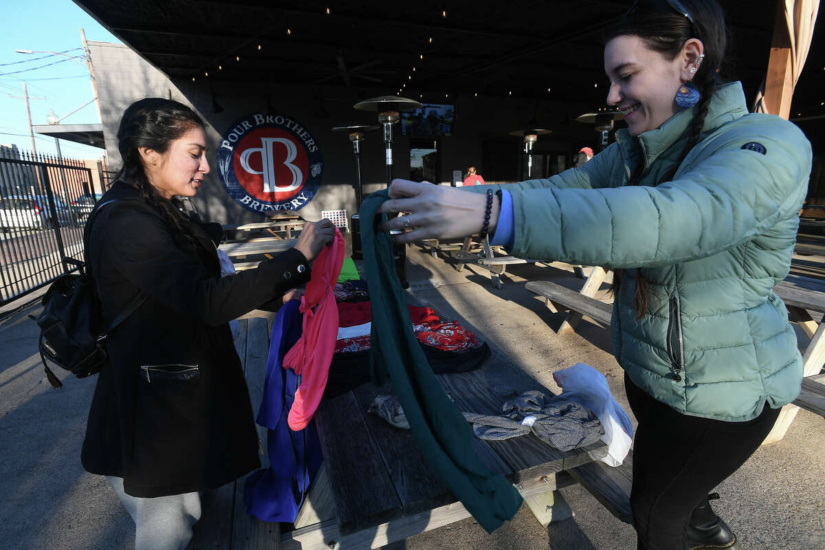 Virginia Johnson (right) talks with fellow swapper Genesis Martinez during the IDKY Purse/Clothes Swap event Thursday night at Pour Brothers. Photo made Thursday, January 26, 2023 Kim Brent/Beaumont Enterprise