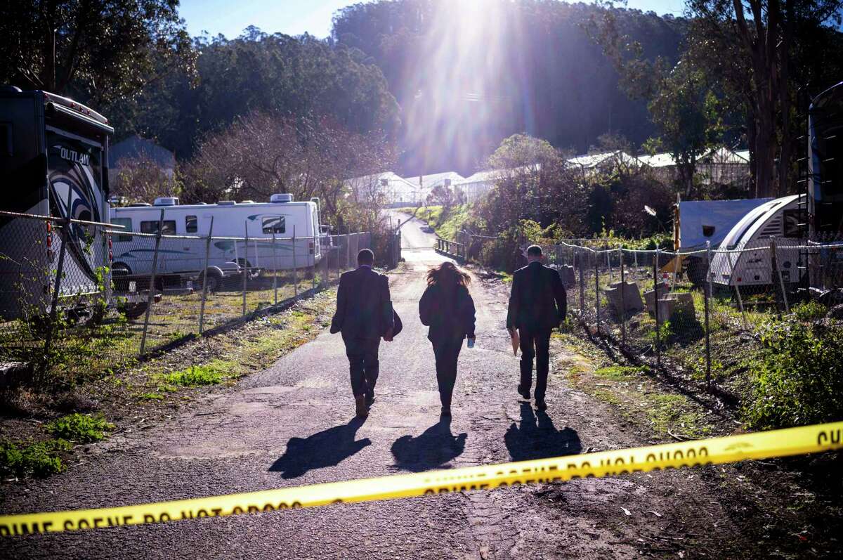 FBI officials walk towards the crime scene at Mountain Mushroom Farm, Tuesday, Jan. 24, 2023, after a gunman killed several people at two agricultural businesses in Half Moon Bay, Calif. Officers arrested a suspect in Monday's shootings, 67-year-old Chunli Zhao, after they found him in his car in the parking lot of a sheriff's substation, San Mateo County Sheriff Christina Corpus said.