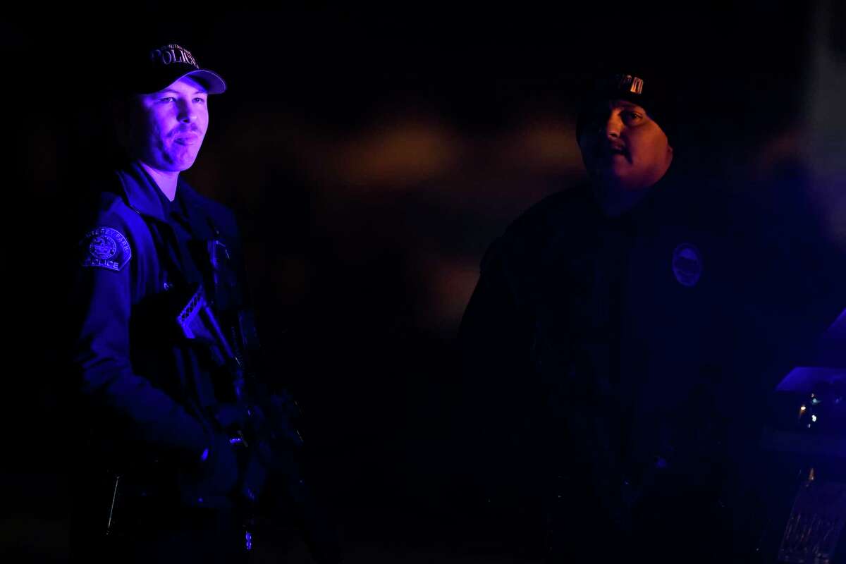 Police officers stand guard near a scene where a shooting took place in Monterey Park, Calif., Sunday, Jan. 22, 2023. Several were killed in a mass shooting late Saturday in a city east of Los Angeles following a Lunar New Year celebration that attracted thousands, police said.