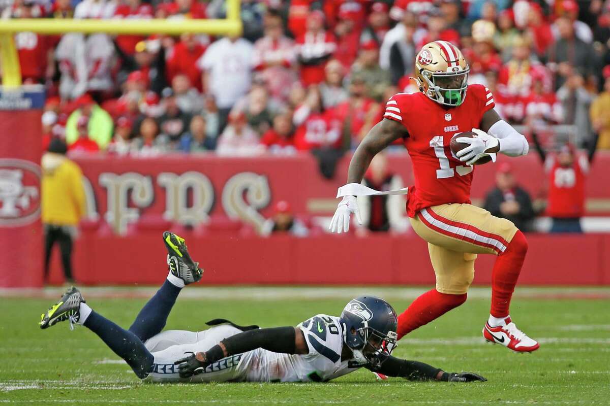 San Francisco 49ers wide receiver Deebo Samuel (19) gets past Seattle Seahawks cornerback Mike Jackson (30) for a gain in the second quarter of an NFL wild-card round playoff game at Levi’s Stadium in Santa Clara, Calif., Saturday, Jan. 14, 2023.