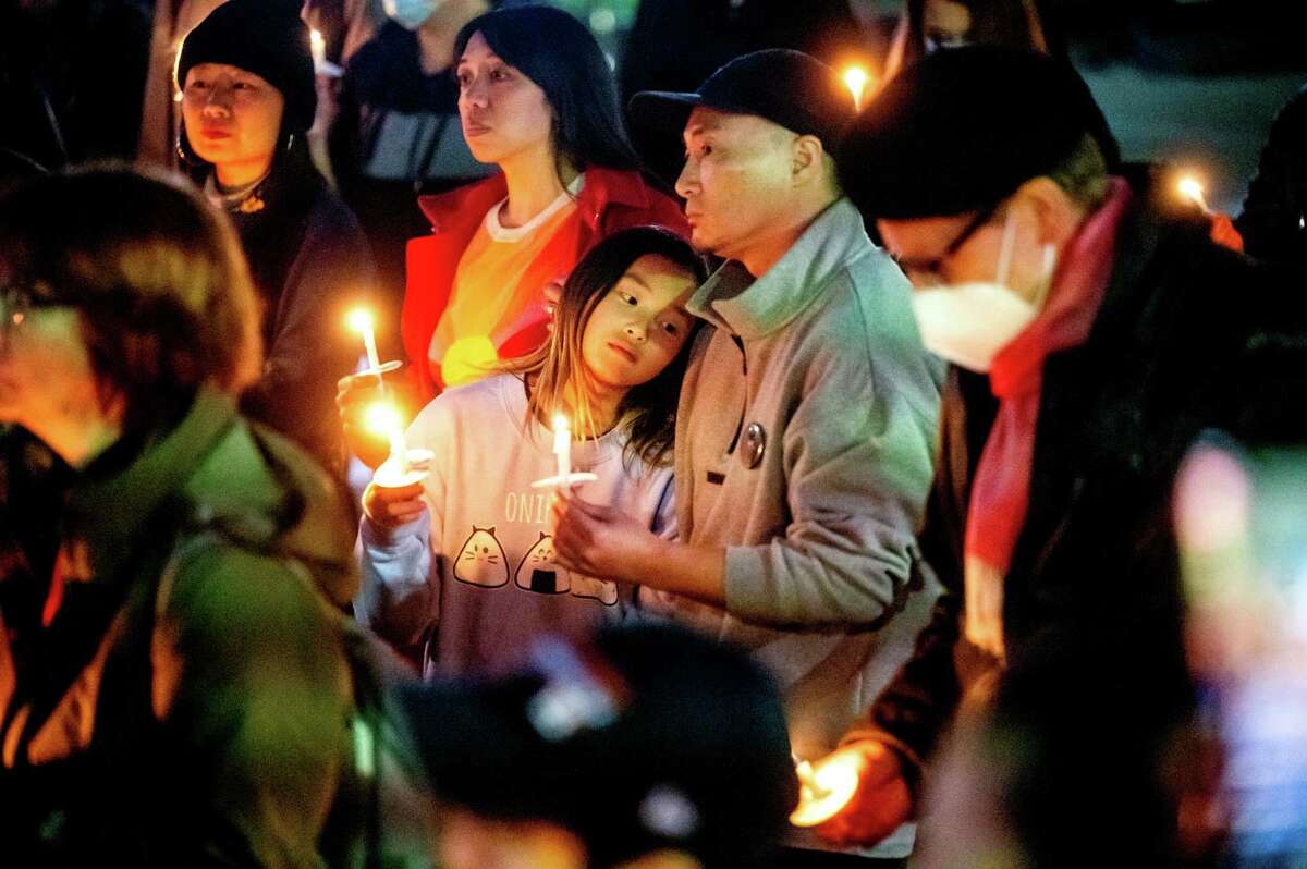 Will, who declined to give a last name, holds a candle during a Portsmouth Square vigil for recent mass shooting victims on Thursday, Jan. 26, 2023, in San Francisco, Calif.