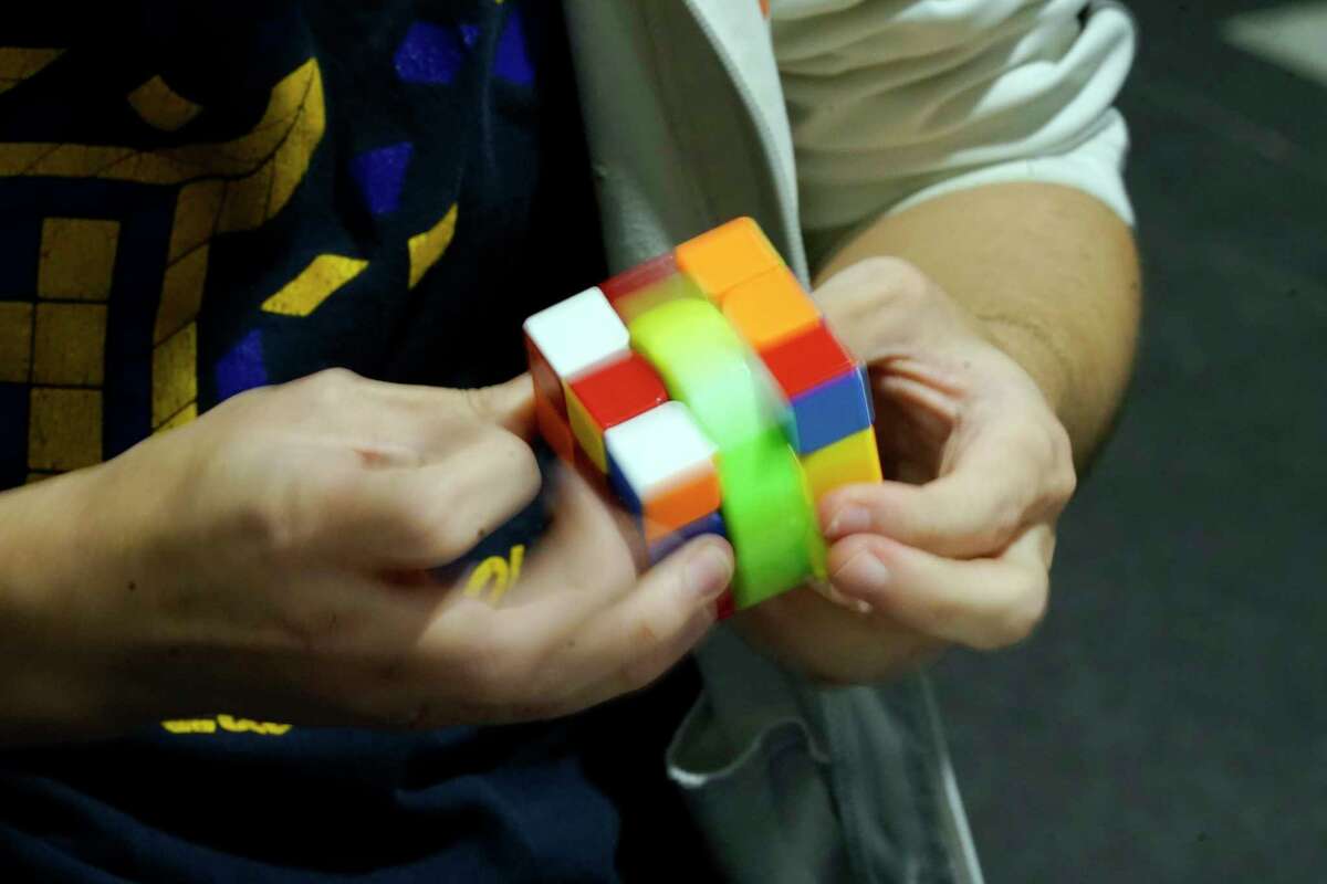 University of Michigan student Stanley Chapel solves a Rubik's Cube while blindfolded, Wednesday, Nov. 23, 2022, in Ann Arbor, Mich. Stanley is one of the world's foremost "speedcubers," a person capable of quickly solving a Rubik's Cube. He also is an accomplished violinist. Chapel says the two fields aren't as different as one might think. Chapel has certain inherent abilities -- he is capable of remembering and applying thousands of algorithms to solve a Rubik's Cube and performing one of Johann Sebastian Bach's violin sonatas from memory.