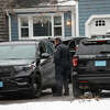 Duxbury Police work at the scene where two children were found dead and an infant injured, Wednesday, Jan. 25, 2023, in Duxbury, Mass. Authorities. responding Tuesday night to reports of a woman jumping out of a window at a house, found them unconscious with obvious signs of trauma. The mother, Lindsay Clancy, remains hospitalized and will be arraigned on homicide charges after she is released, Plymouth District Attorney Timothy Cruz said Wednesday. (David L Ryan/The Boston Globe via AP)