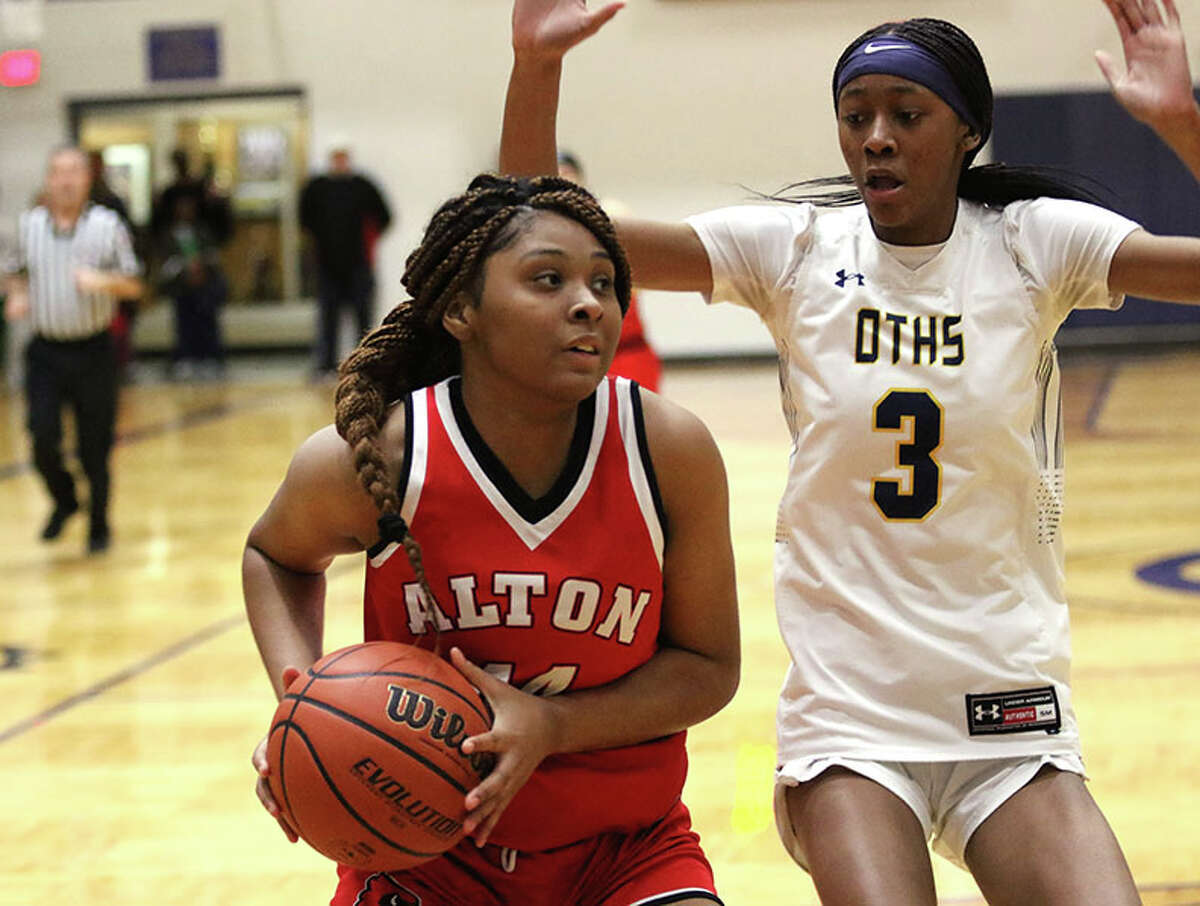 Alton's Jarius Powers takes the ball to the basket against O'Fallon's D'Myjah Bolds (3) in a SWC girls basketball game Thursday night at Panther Dome in O'Fallon. Powers led all scorers with 17 points in the game.
