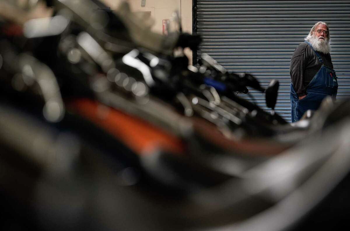 Joel Morris looks down a row of motorcycles Wednesday, Jan. 18, 2023, at San Jacinto Harley-Davidson in Pasadena.