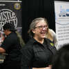 Mary Thorn, owner of the Thistle Draft Shop, speaks with visitors during Taste of the Town, Thursday, January 26, 2023, inÂ The Woodlands.