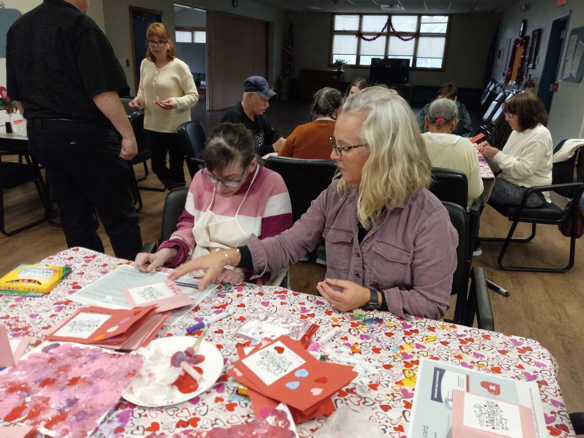 The Winsted Senior Center held a valentine workshop Thursday for its senior enrichment program. Center director Jen Kelly, right, helps Anna Persechino with her card.