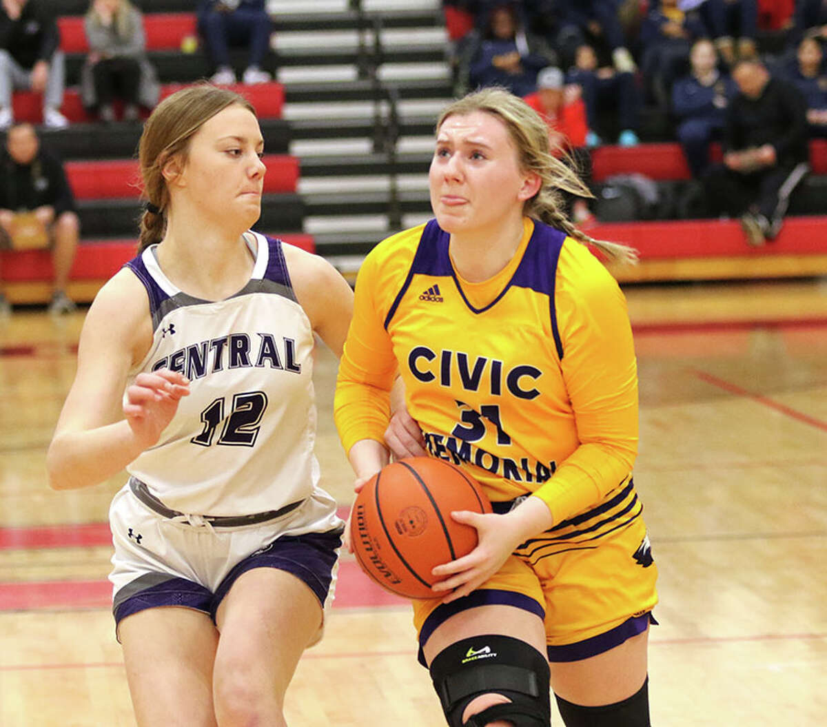 CM's Olivia Durbin (right), shown taking the ball to the basket against Breese Central's Cece Toennies in a game last week at the Highland Tournament, scored 21 points Thursday night in a road win at Triad to reach 1,000 points in her career.