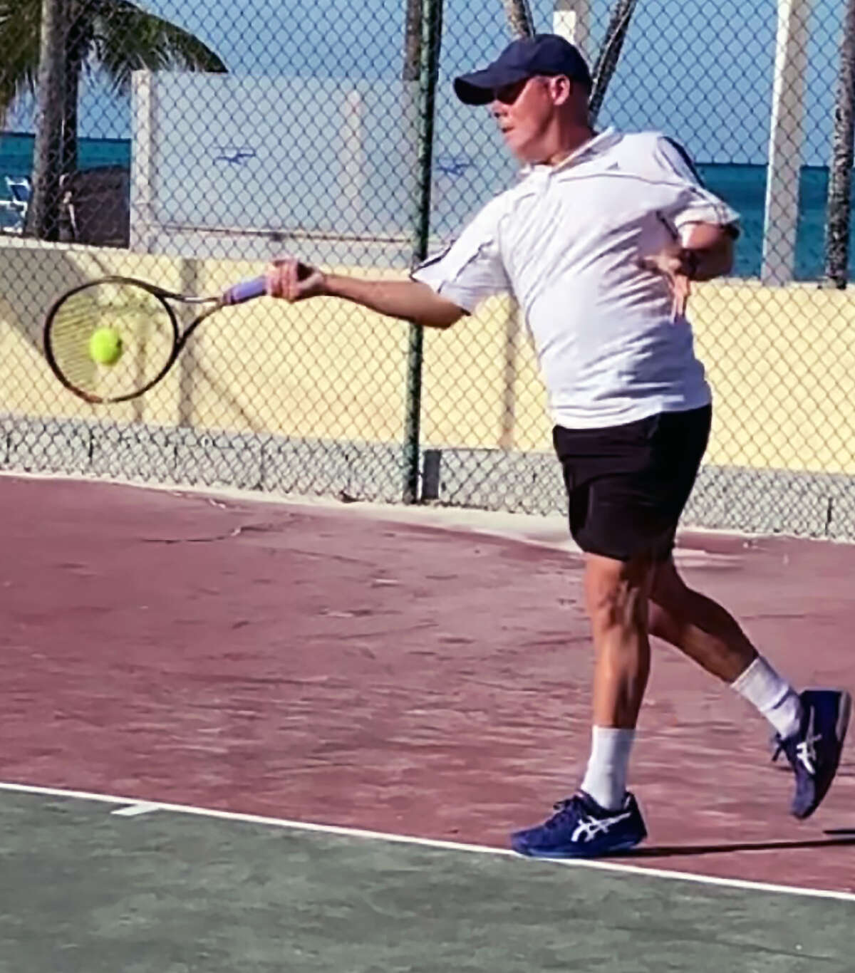 Alton native Steve Moehn of the United States International Club Team makes a return during action in the IC Bahamas Doubles Tournament last week at the Nassau Bahamas Lawn and Tennis Club.