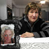 Valerie Booth, Jennifer Sullivan’s mother, poses with a photograph of her daughter during an interview in her home in Milford, Conn. Jan. 27, 2023. Sullivan has been missing for over a year.