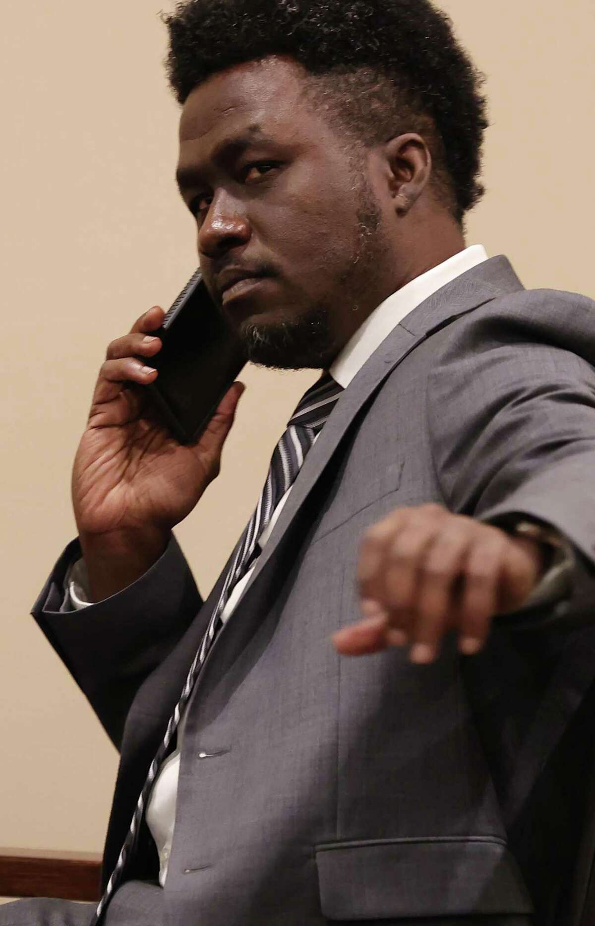 Air Force Reserve Maj. Andre McDonald makes a call before his murder trial resumes Friday in 399th District Court. McDonald is accused of killing his wife, Andreen McDonald.