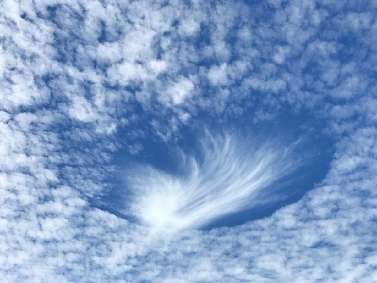 Rare fall streak clouds, which are also known as hole punch clouds, were captured above Central Texas on Thursday. 