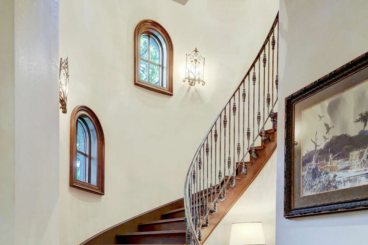 The entry way has reclaimed wood flooring laid in a Versailles pattern