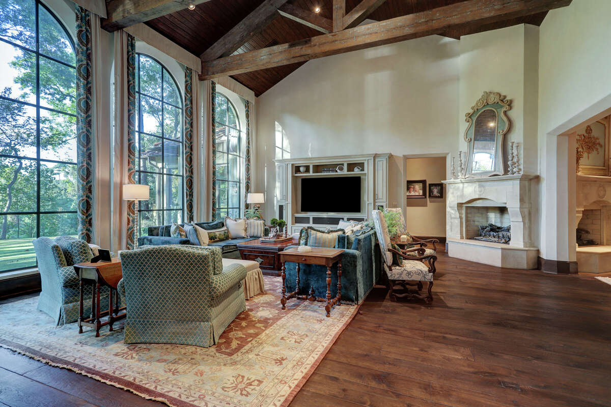 The family room has a vaulted two story ceiling with reclaimed wood beams
