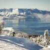 A snowboarded approaches a jump near the Sky Express chairlift overlooking Lake Tahoe at Heavenly Mountain Resort in South Lake Tahoe, Calif. on Tuesday, Jan. 17, 2023.