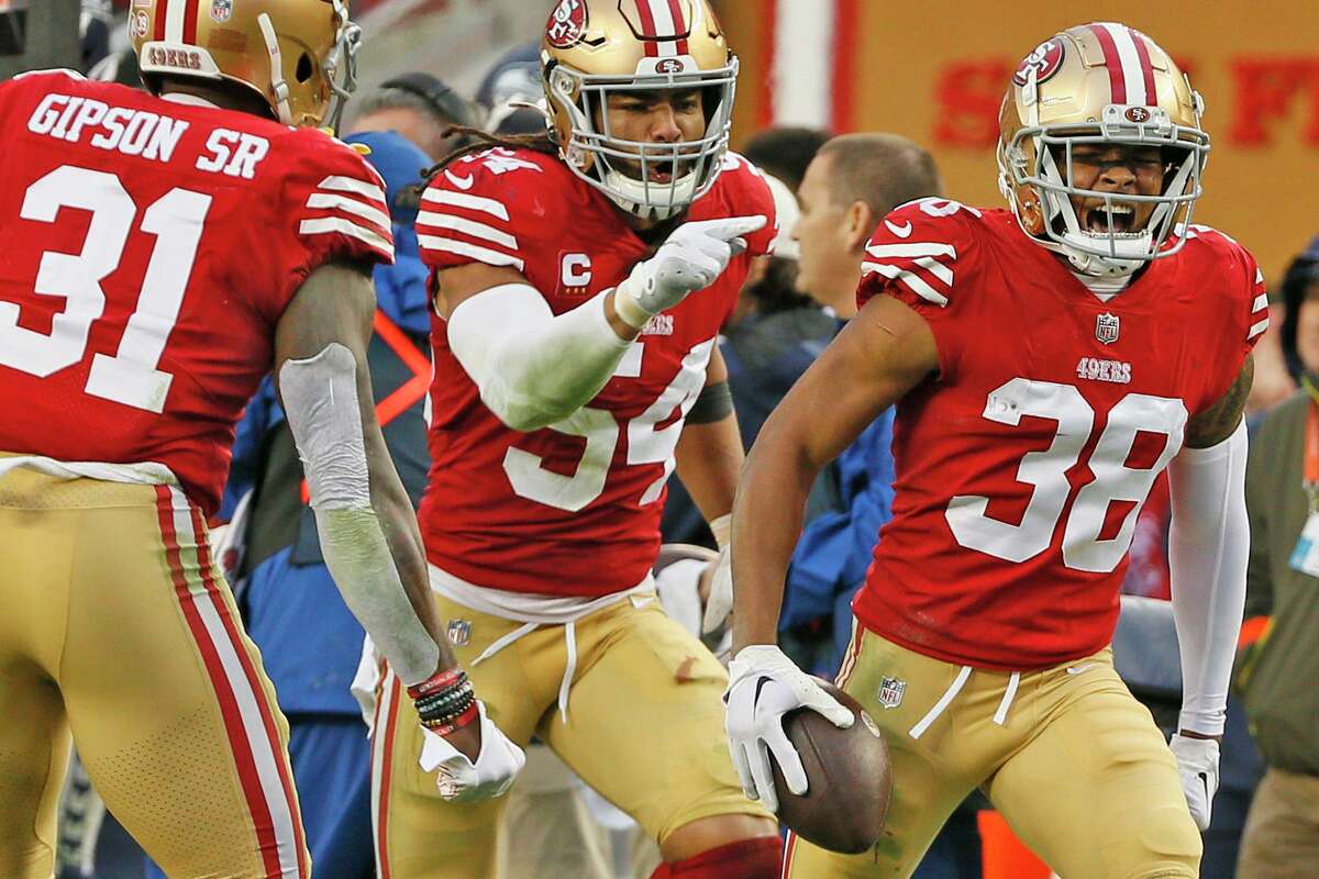 San Francisco 49ers cornerback Deommodore Lenoir (38) celebrates his interception against the Seattle Seahawks in the fourth quarter of an NFL wild-card round playoff game at Levi’s Stadium in Santa Clara, Calif., Saturday, Jan. 14, 2023.