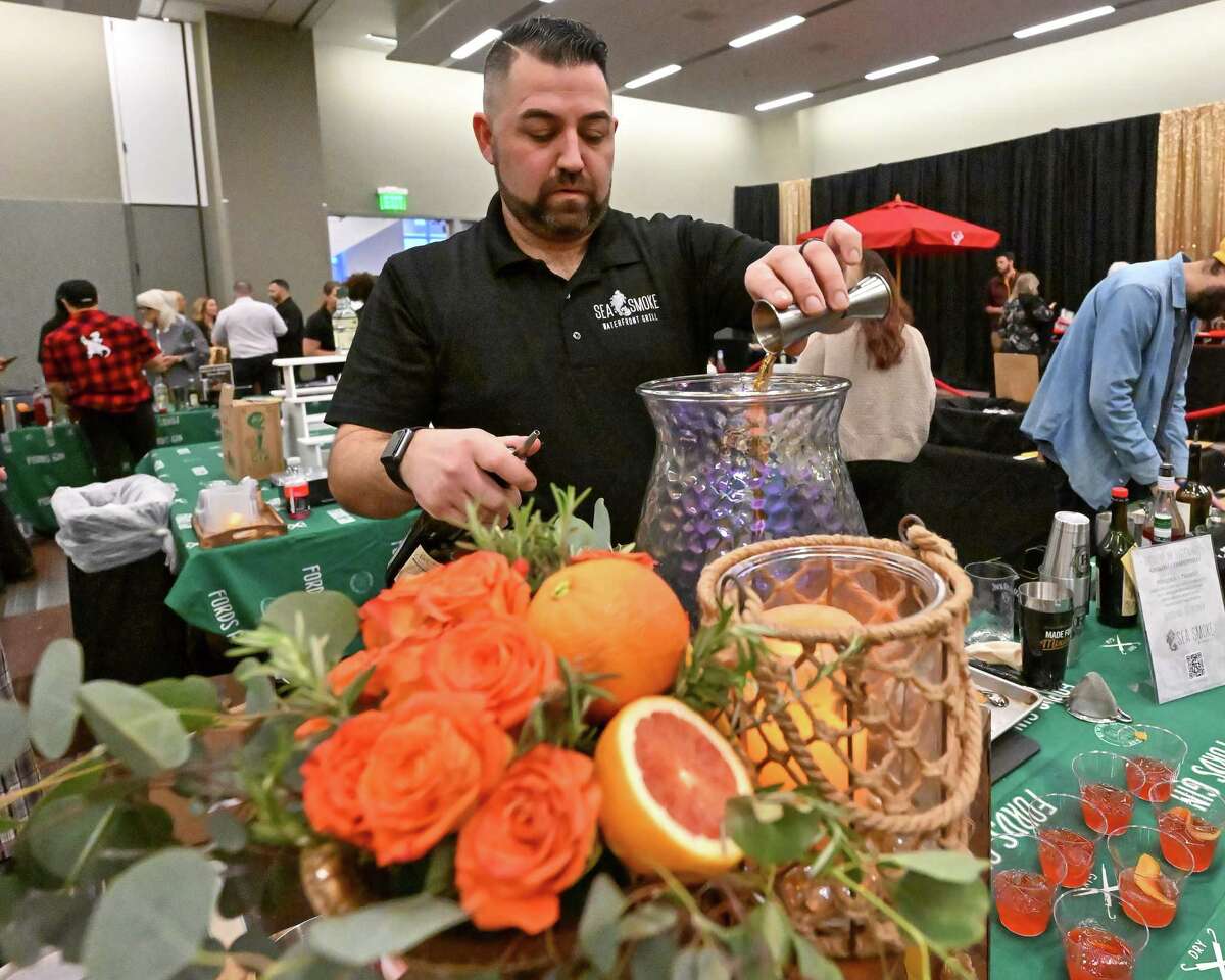 Joe Heaney makes a Poseidon’s trident negroni at the Sea Smoke station during the Albany Chefs’ Food & Wine Festival on Friday, Jan. 27, 2023, at the Capital Center in Albany, NY.
