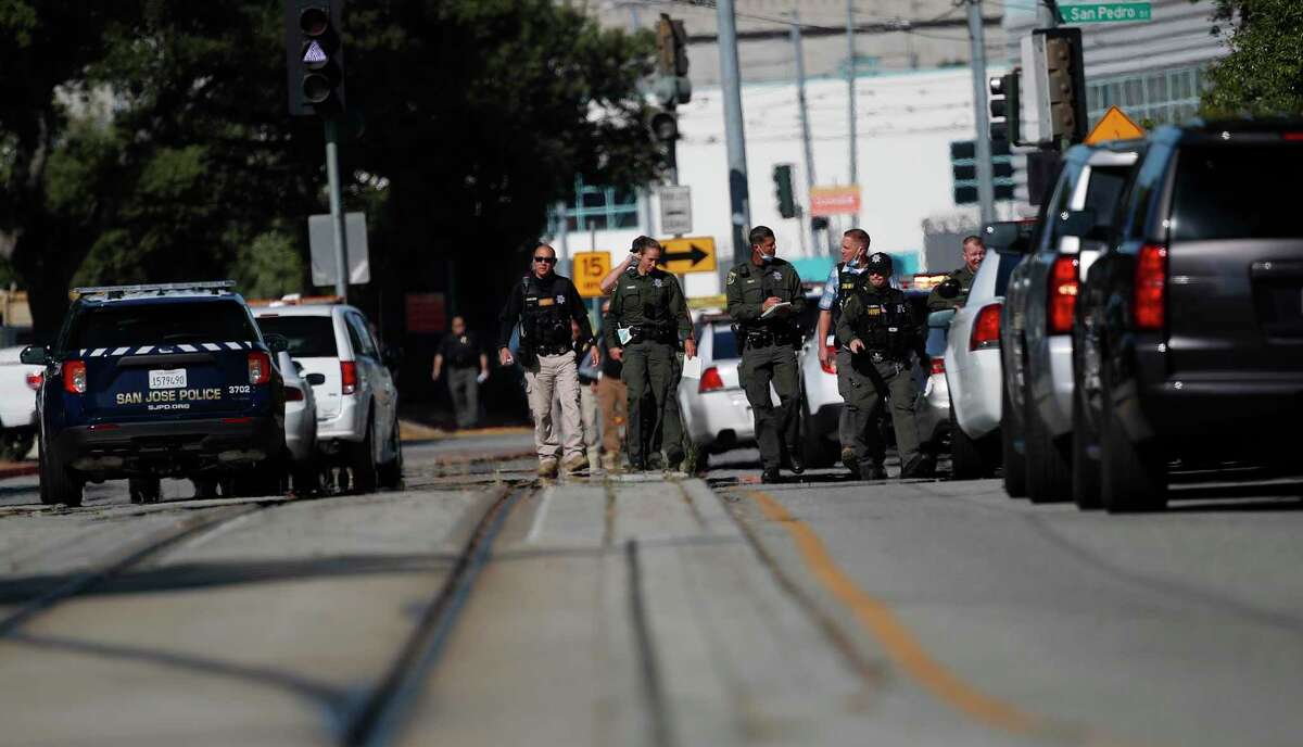 Members of the San Jose Police Department work the perimeter of the scene where a mass shooting occurred May 26, 2021. A month after the railyard shooting, San Jose became the first city in the nation to adopt a policy requiring gun owners to carry liability insurance and to pay an annual gun harm reduction fee.