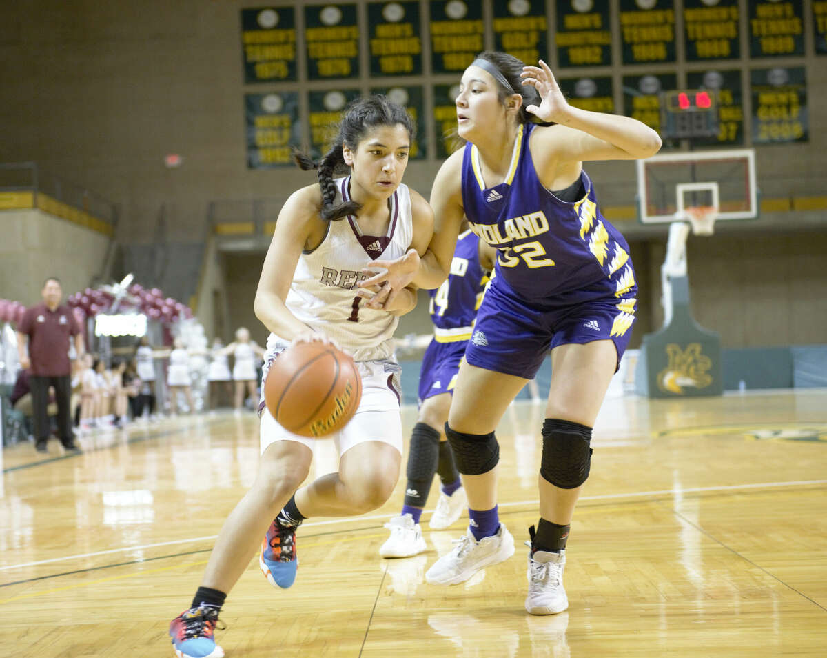 Legacy's Natalie Magallanes dribbles against Midland High's Hannah Lujan during a District 2-6A girls basketball game, Jan. 27 at Chaparral Center. 