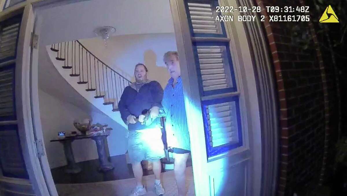 This image from video from police body-worn camera footage, released by the San Francisco Police Department, shows Paul Pelosi, right, fighting for control of a hammer with his assailant, David DePape, during a attack at Pelosi's home in San Francisco on Oct. 28, 2022. DePape wrests the tool from Pelosi and lunges toward him the hammer over his head. The blow to Pelosi occurs out of view of the video as officers rush into the house and subdue DePape.