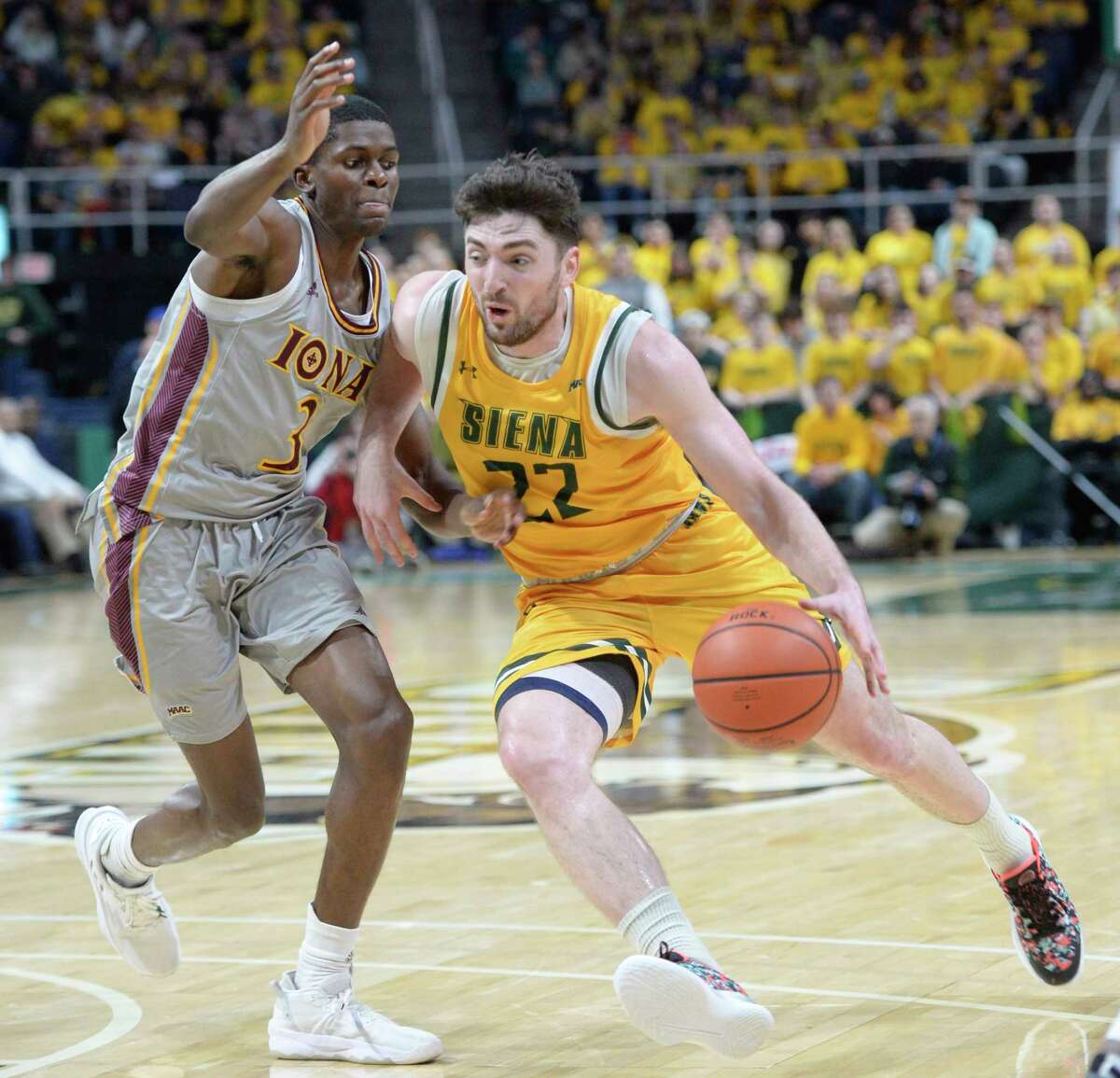 Siena’s Andrew Platek drives the ball past Iona’s Cruz Davis during a game at MVP Arena in Albany, N.Y. on Friday, Jan. 27, 2023. (Jenn March, Special to the Times Union)