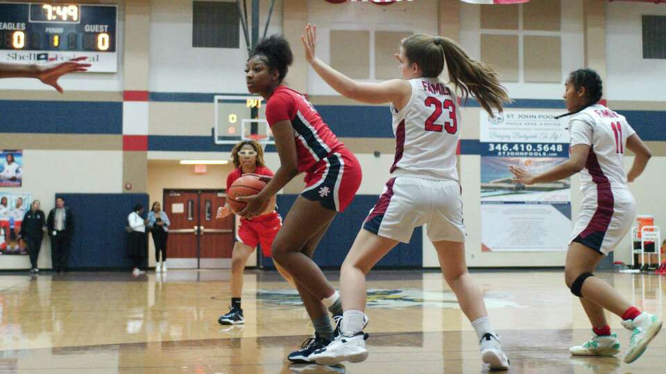 Alief Taylor's Nataliyah Gray (22) is guarded by Dawson's Sarah Allison (23) Friday, Jan. 27, 2023 at Dawson High School.