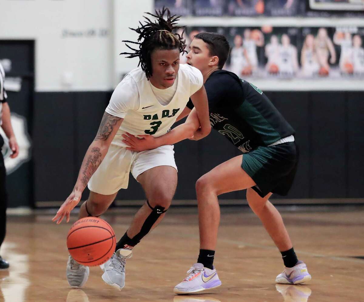 Kingwood Park’s Davion Sanford (3) is fouled as he drives around Huntsville’s Brett Butler, right, during their District 16-5A basketball game, held at Kingwood Park High School Friday, Jan. 27, 2023 in Kingwood, TX.