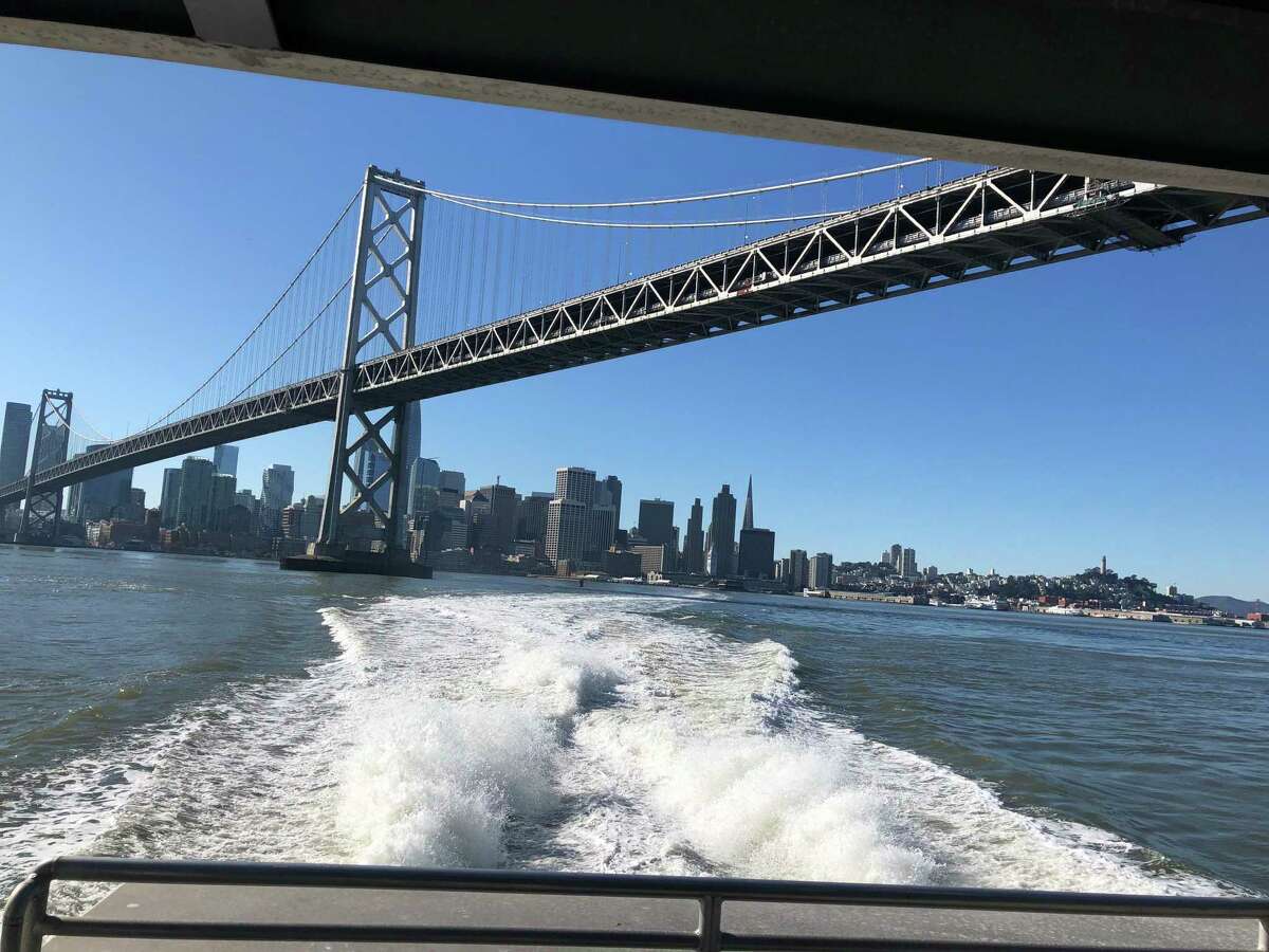 The sleek, modern ferry Argo zips under the Bay Bridge en route across the bay to Oakland.
