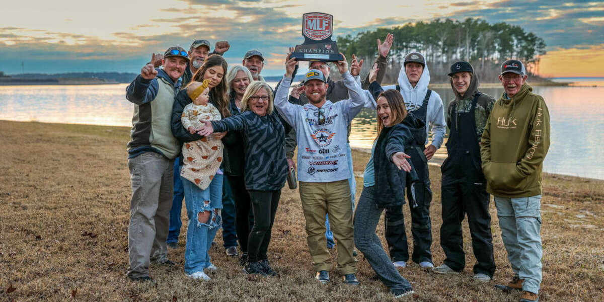 Southeast Texan Dakota Ebare poses with family and friends after winning the  Major League Fishing Toyota Series season open on Sam Rayburn. 