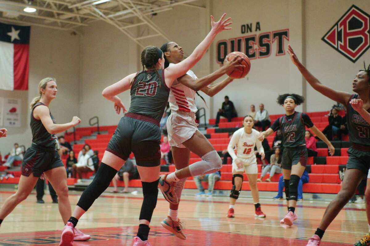 Clear Brook’s Kamryn Mclaurin (4) drives to the basket past Clear Creek’s Olivia Shaw (20) Saturday, Jan. 28, 2023 at Clear Brook High School.