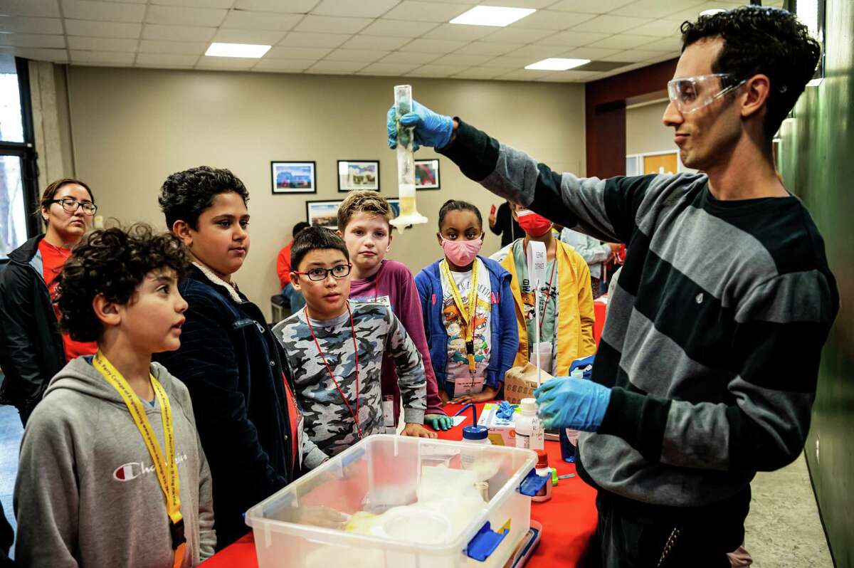 Austin Morales, a Chemical and Biomolecular Engineering graduate student, demonstrates the “Elephant Toothpaste” experiment for students during STEM Zone Saturday, on January 28, 2023 at The University of Houston in Houston, Texas.