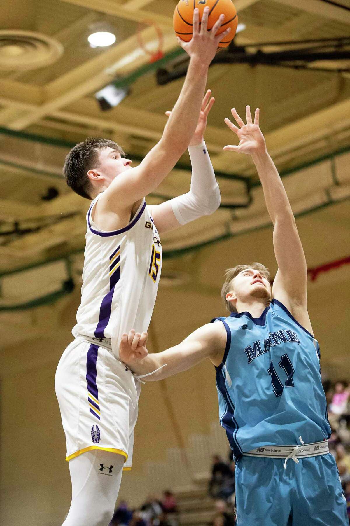 Albany’s Jonathan Beagle shoots the ball above the defending hands of Maine’s Kristians Feierbergs during a game at McDonough Sports Complex in Troy, N.Y. on Saturday, Jan. 28, 2023. (Jenn March, Special to the Times Union)