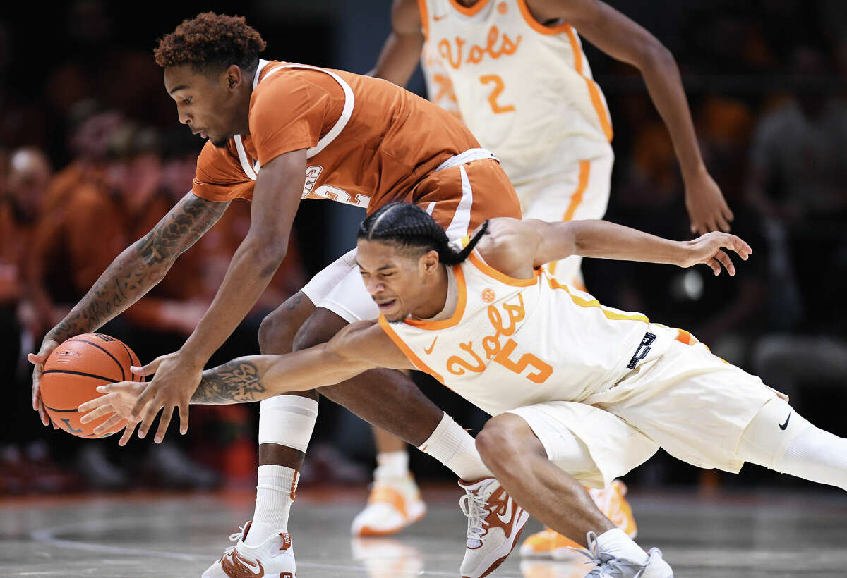 KNOXVILLE, TENNESSEE - JANUARY 28: Arterio Morris #2 of the Texas Longhorns and Zakai Zeigler #5 of the Tennessee Volunteers reach for a loose ball in the second half of the game at Thompson-Boling Arena on January 28, 2023 in Knoxville, Tennessee. (Photo by Eakin Howard/Getty Images)