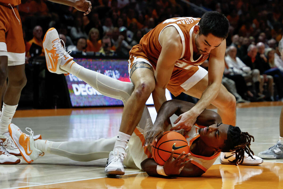 Tennessee forward Jonas Aidoo, bottom, beats Texas forward Brock Cunningham to a loose ball during the Volunteers' home victory over the Longhorns on Saturday. 