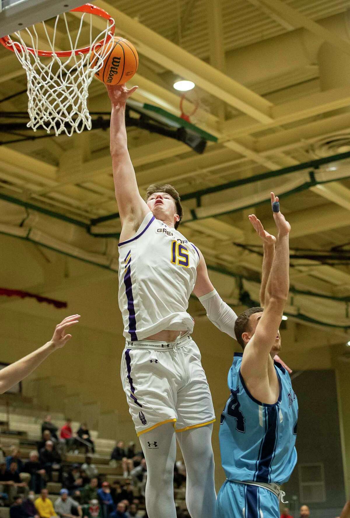 Albany’s Jonathan Beagle shoots the ball as he jumps over Maine’s Peter Filipovity during a game at McDonough Sports Complex in Troy, N.Y. on Saturday, Jan. 28, 2023. (Jenn March, Special to the Times Union)