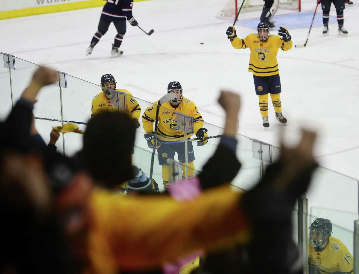 Quinnipiac's players and fans celebrate the game winning third period goal by Jake Johnson in their 4-3 victory over UCONN in the finals of the annual Connecticut Ice college hockey tournament at Quinnipiac University in Hamden, Conn. on Friday, January 27, 2023.