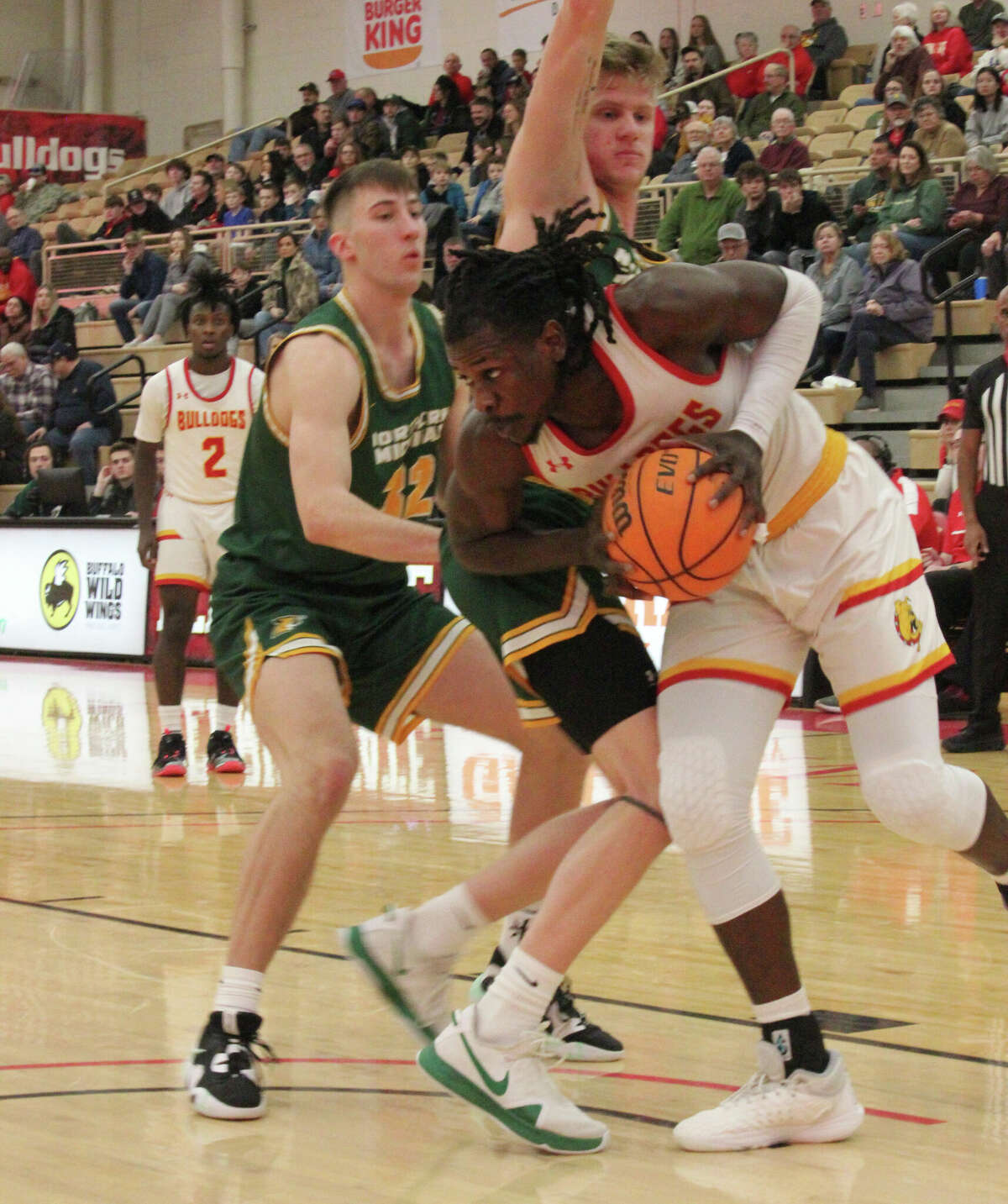 Ferris' Dolapo Olayinka drives to the basket against Northern Michigan's defense on Saturday at Wink Arena.