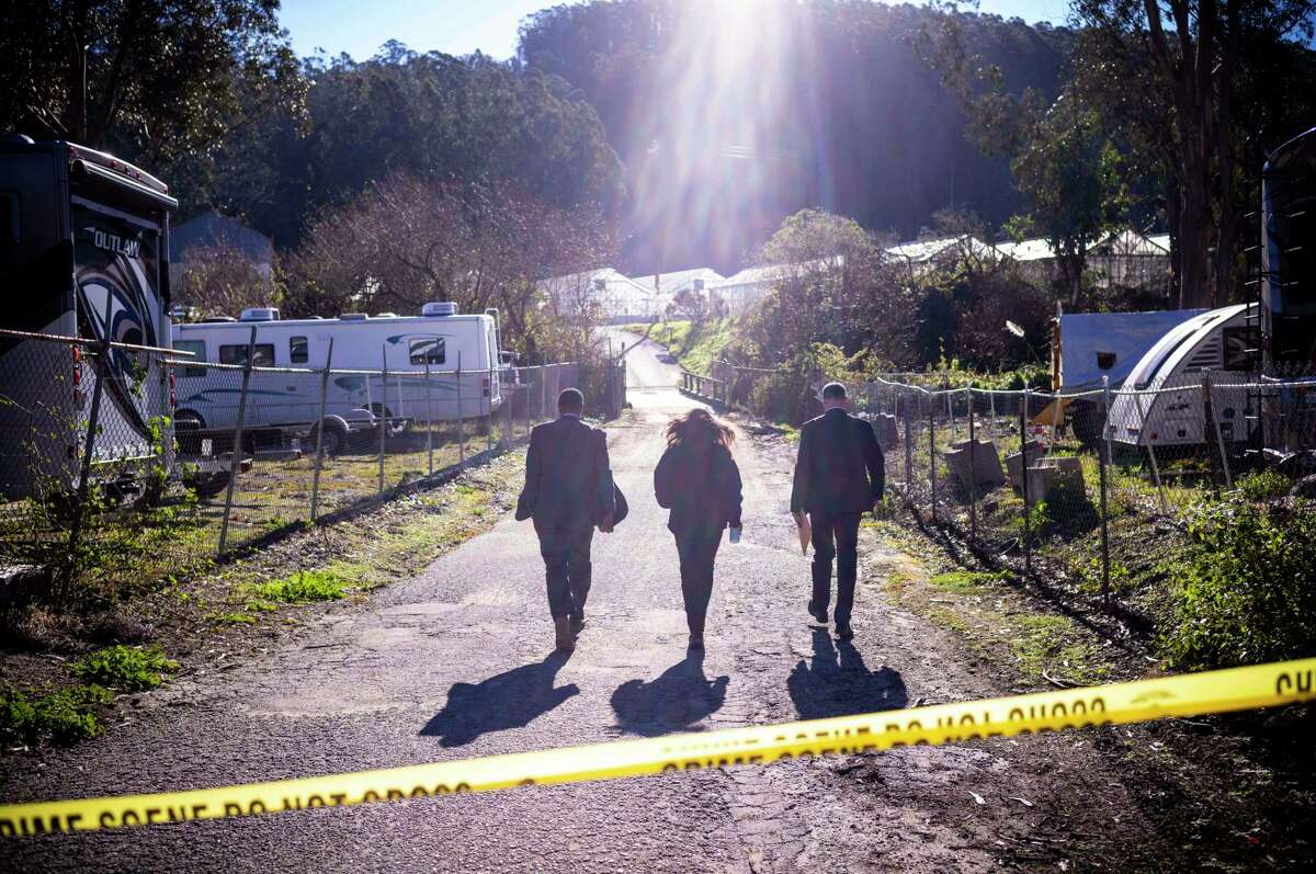 FILE - FBI officials walk towards the crime scene at Mountain Mushroom Farm, Tuesday, Jan. 24, 2023, after a gunman killed several people at two agricultural businesses in Half Moon Bay, Calif. Officers arrested a suspect, 67-year-old Chunli Zhao, after they found him in his car in the parking lot of a sheriff's substation, San Mateo County Sheriff Christina Corpus said.