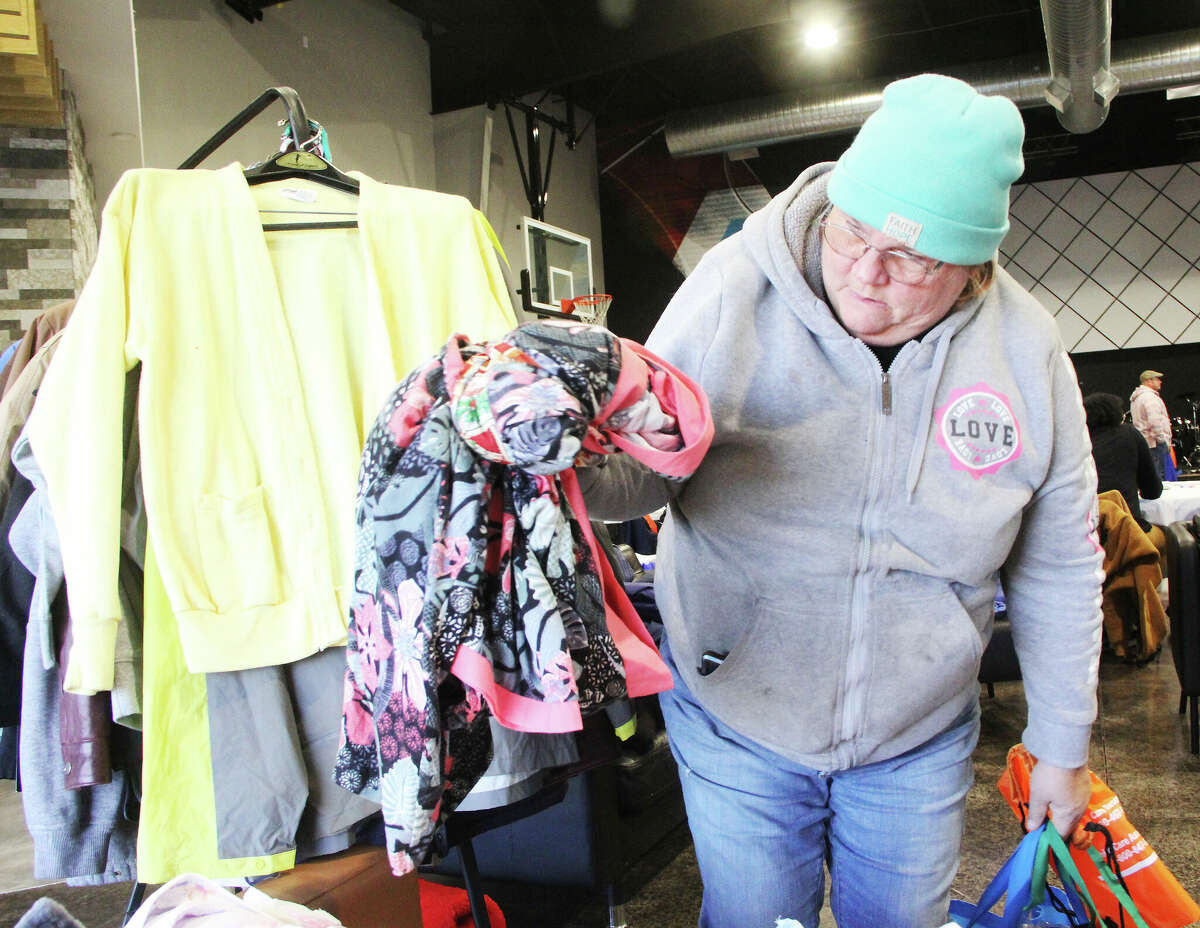 Amelia Goers of Alton looks over clothing during Homeless Connect, held Saturday at River of Life Church in Alton. Multiple agencies and nonprofits provide everything from health screenings to help with transportation for the homeless or those trying to avoid homelessness. Prior to COVID it was an annual event, and this was the first held since 2019.