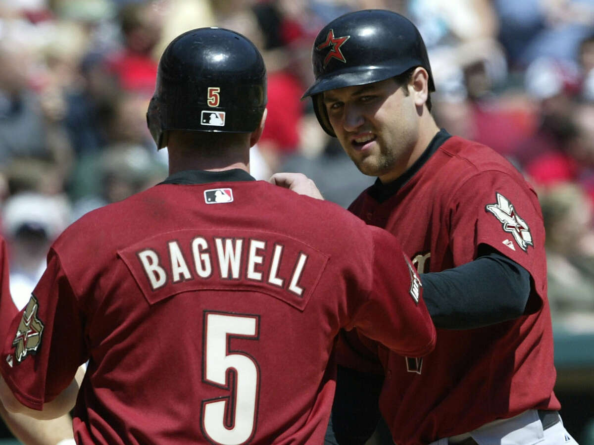 Lance Berkman #17 of the Houston Astros is congratulated by teammate Jeff Bagwell #5 after Berkman hit a 3-run homer against the St. Louis Cardinals on April 14, 2004 at Busch Stadium in St. Louis, Missouri.
