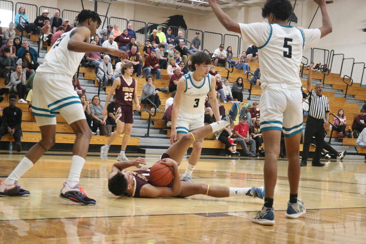 Deer Park's Nicholas Buffalo hits the court in going after a ball. He is surrounded by Chance Arriaga, Sebastian Farias and Robert Miller.