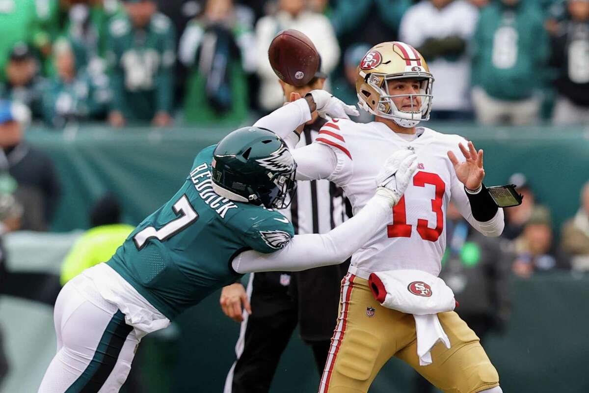 Philadelphia Eagles' linebacker Haason Reddick, 7, hits San Francisco 49ers' quarterback Brock Purdy’s, 13, wrist causing a fumble in the first quarter during the NFC Championship Game at Lincoln Financial Field in Philadelphia, Pa., on Sunday, Jan. 29, 2023.