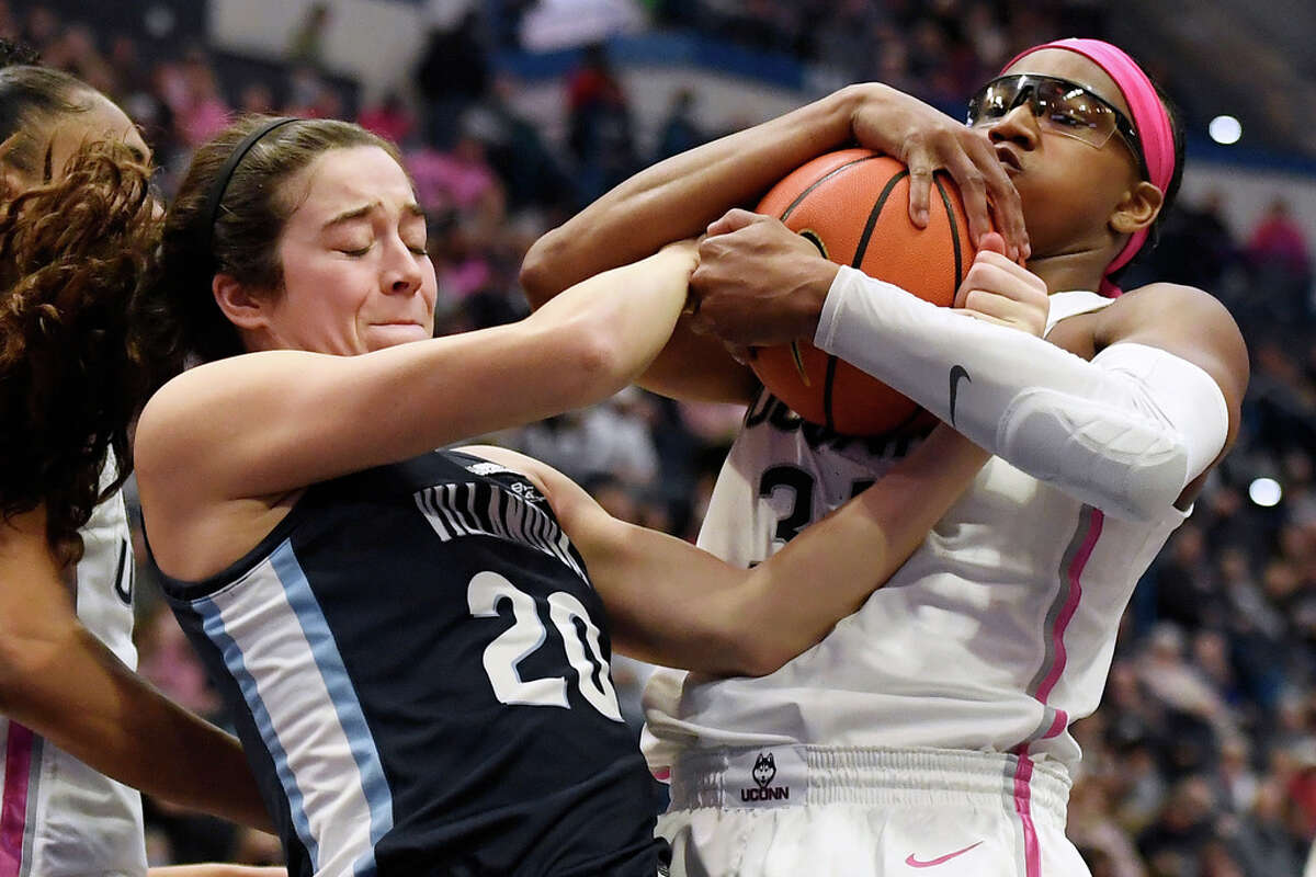 Villanova's Maddy Siegrist, left, and UConn's Ayanna Patterson, right, fight for the ball in the first half of an NCAA college basketball game, Sunday, Jan. 29, 2023, in Hartford, Conn. (AP Photo/Jessica Hill)