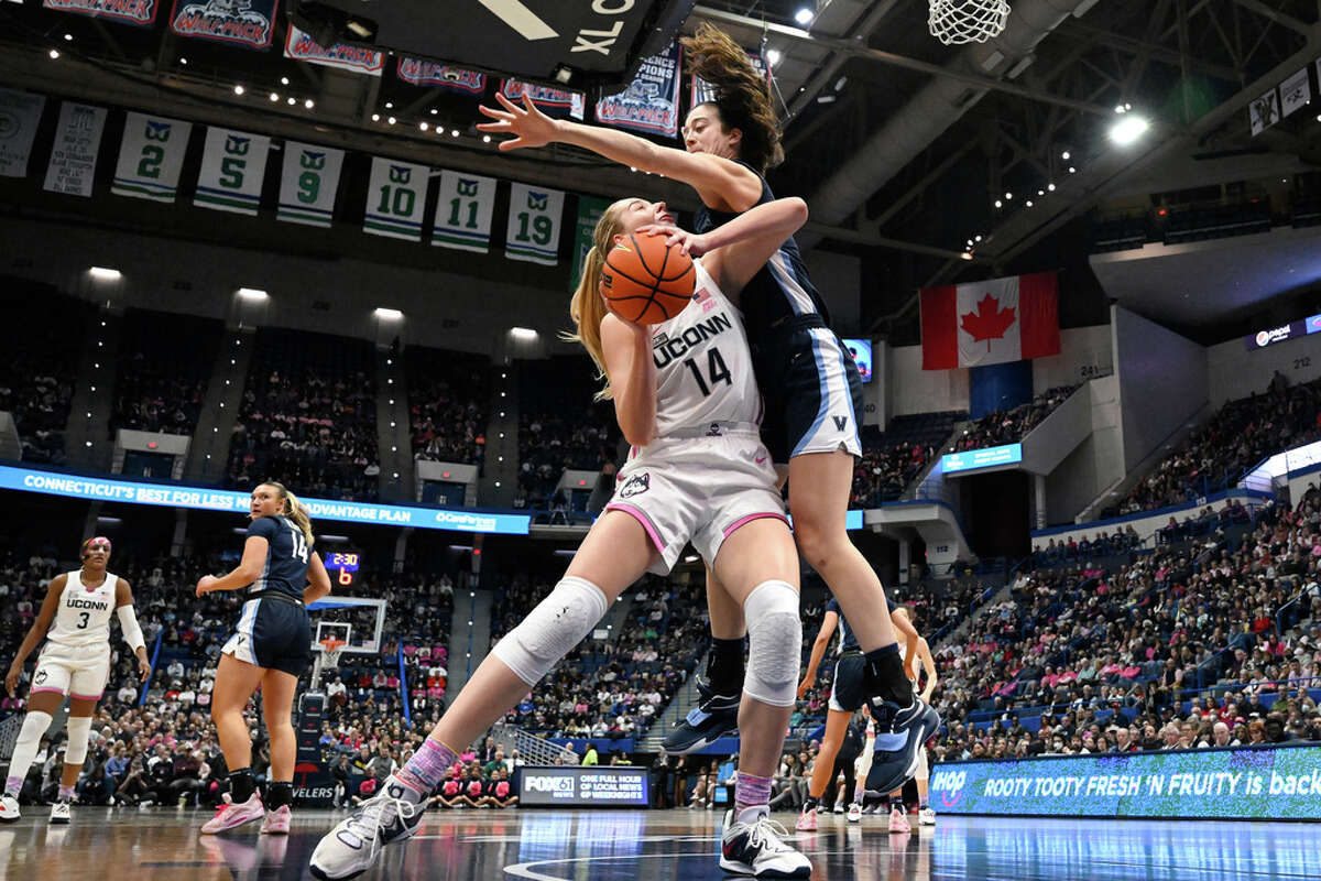 UConn's Dorka Juhasz, left, is pressured by Villanova's Maddy Siegrist in the first half of an NCAA college basketball game, Sunday, Jan. 29, 2023, in Hartford, Conn. (AP Photo/Jessica Hill)